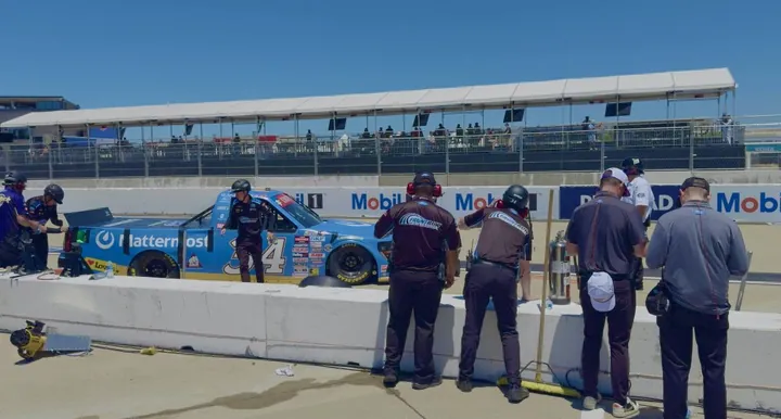 Crew members at the wall beside the No. 34 truck