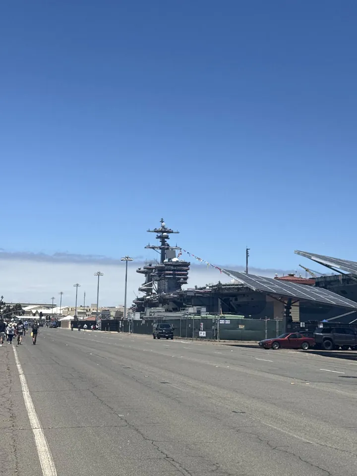 An aircraft carrier docked at the end of a road on the base