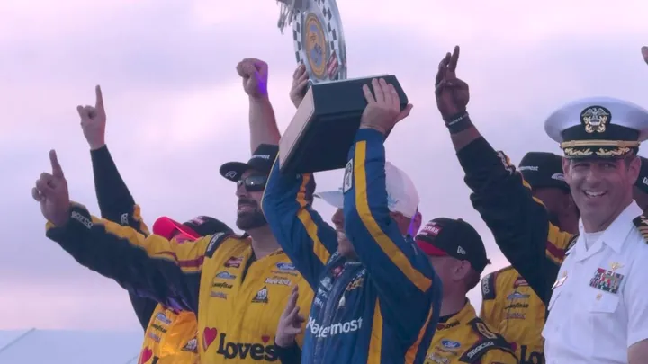 Crew celebrating with the trophy in victory lane