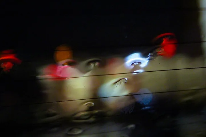 Smeared lights and a face at night